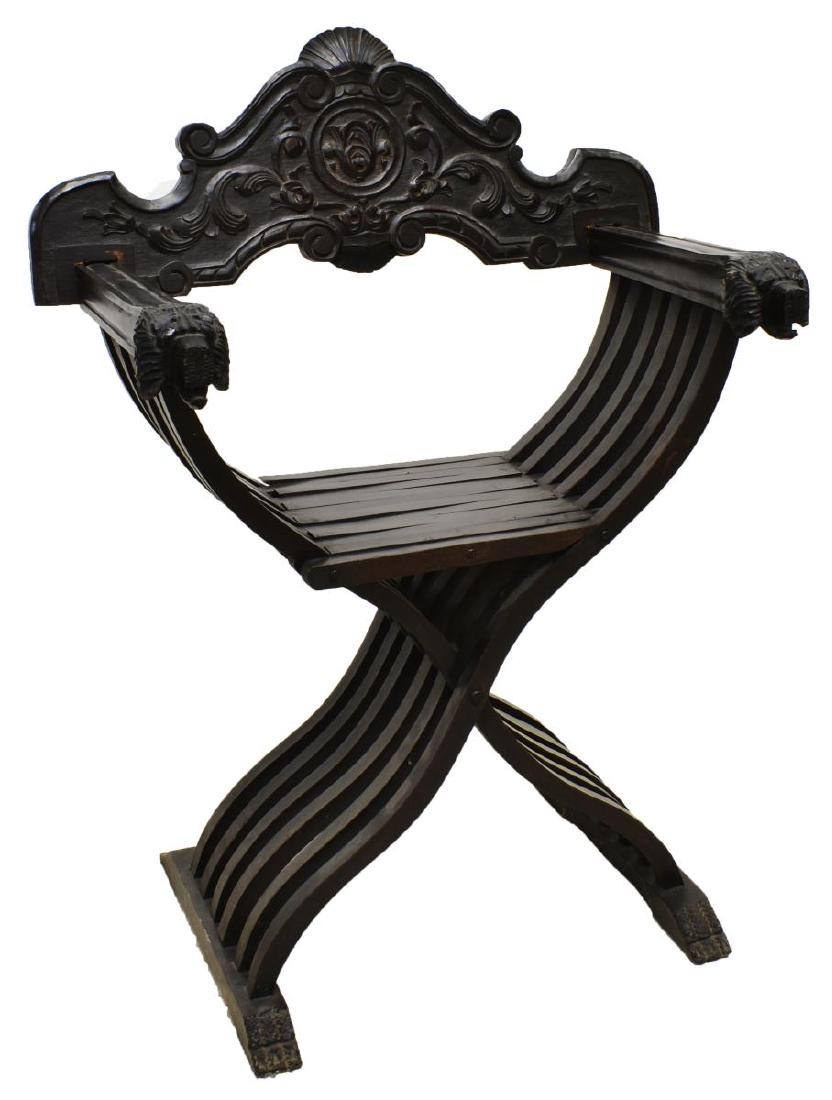 ITALIAN FOLIATE & LION CARVED SAVONAROLA CHAIR: Italian Savonarola chair, 19th c., having backrest carved with foliate, shell and scrollwork elements, the slatted folding frame ending in lion's head handholds, resting on trestle base, approx 36"h,