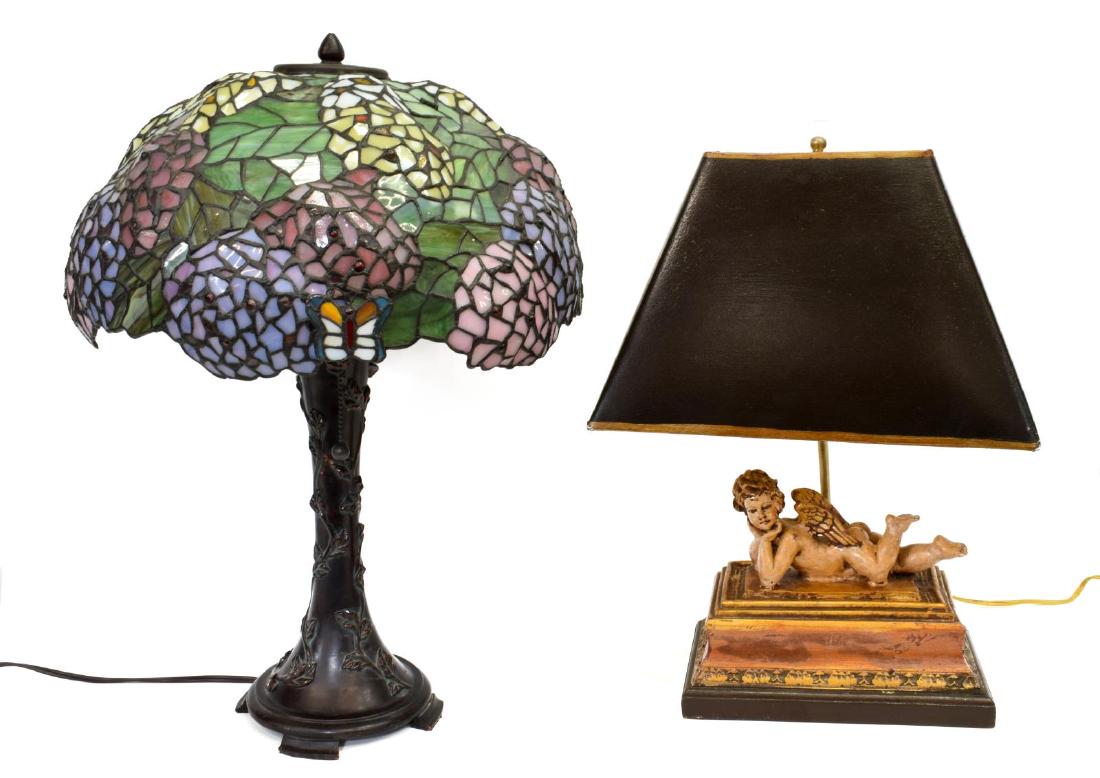 (2) TABLE LAMPS, BUTTERFLY & RECLINING CHERUB: (lot of 2) Butterfly and reclining cherub table lamps, cast resin, 20th c.; (1) two-light table lamp, in a bronze finish, having faux stained and leaded glass shade, with attached butterfly accent, en
