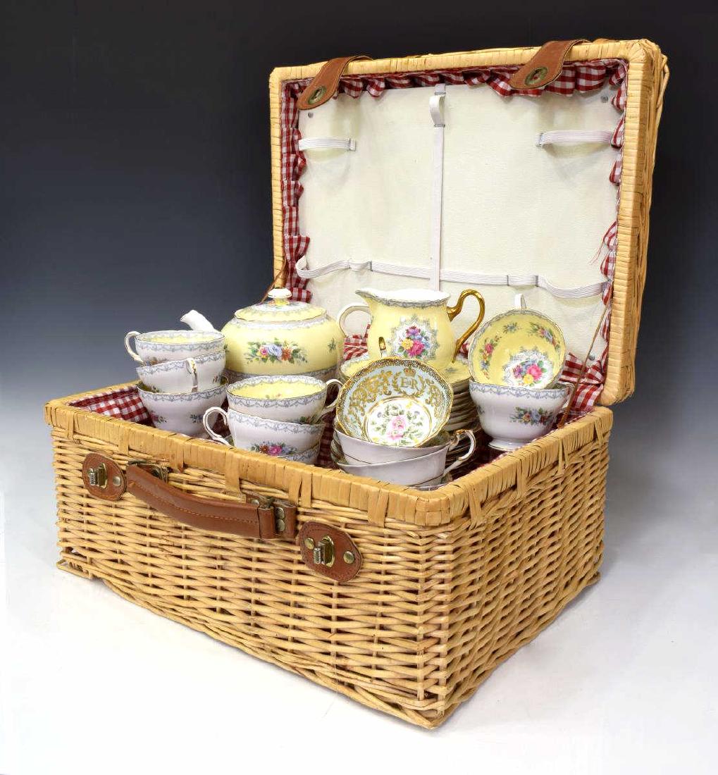 (31) ENGLISH BONE CHINA TEA SERVICE WITH BASKET: (lot of 31) English bone china tea and dessert services (varied patterns) presented in an unassociated wicker and leather picnic basket: (set) Shelley "Crochet" bone china tea service, including (8) t