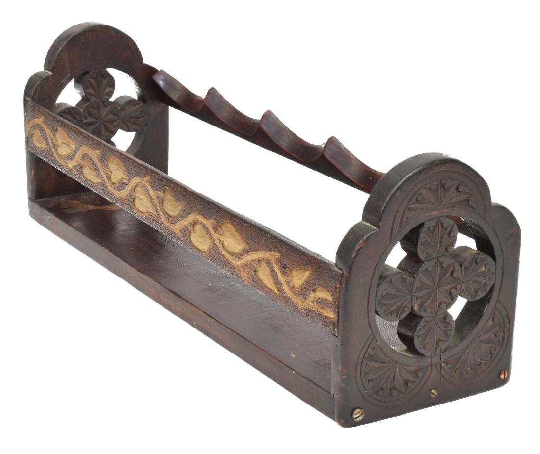 FOLK ART CHIP CARVED WINE BOTTLE HOLDER RACK: Folk Art wine bottle holder, supports five bottles, ends with pierced chip carved rosettes, back rail with parcel gilt ivy motif, approx 6.75"h, 20.5"l, 5.75"w, 2.75lbs Start Price: $50.00