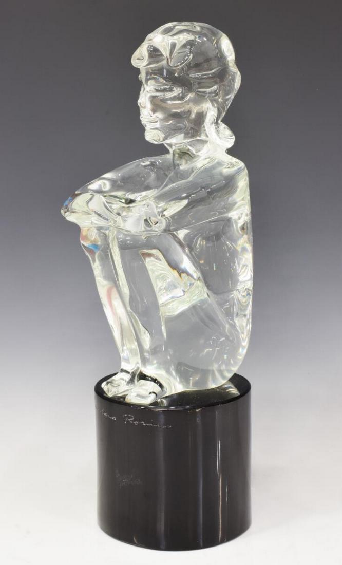 LOREDANO ROSIN (D.1991) MURANO ART GLASS SCULPTURE: Italian Murano art glass sculpture, engraved signature Loredano Rosin (Italy, 1936-1991), seated female nude, over black cylindrical base, approx 16"h, base: approx 5"diam, 18.75lbs Start Price: $150.