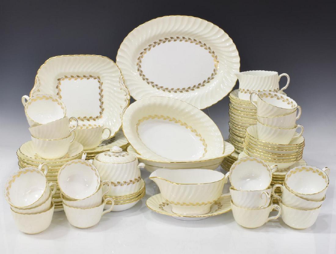 (111) ENGLISH MINTON 'CHEVIOT GOLD' DINNER SERVICE: (lot of 111) Extensive English Minton bone china partial dinner service, in the 'Cheviot Gold' pattern, featuring a gilt design against a cream toned ground with scallop border and gilt rim, each with
