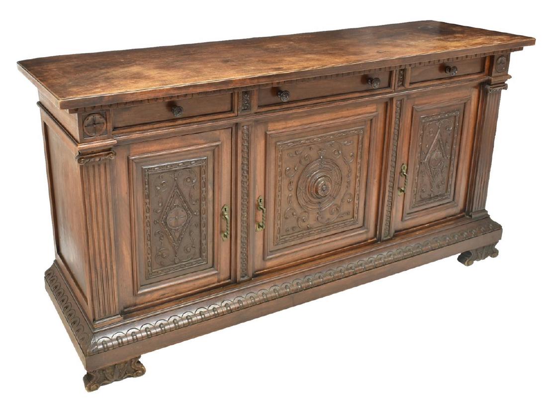 ITALIAN RENAISSANCE REVIVAL CARVED SIDEBOARD: Italian Renaissance Revival carved walnut sideboard, late 19th c., the rectangular top over three drawers above three carved faced doors, the protruding base over volute supports, approx 39"h, 75.5"w,