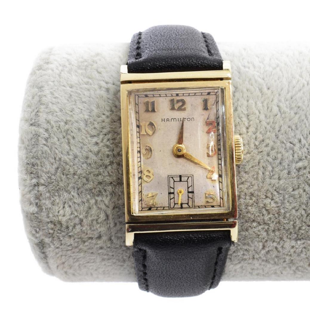 HAMILTON 14KT GOLD 19 JEWEL WRISTWATCH, M982: Hamilton wristwatch Model 982 housed in14kt gold case, 19 jewel movement, silver finish face with gilt numbers and hands, leather band, observed operating, case: approx 1"h, 0.75"w, band: approx 9"l (