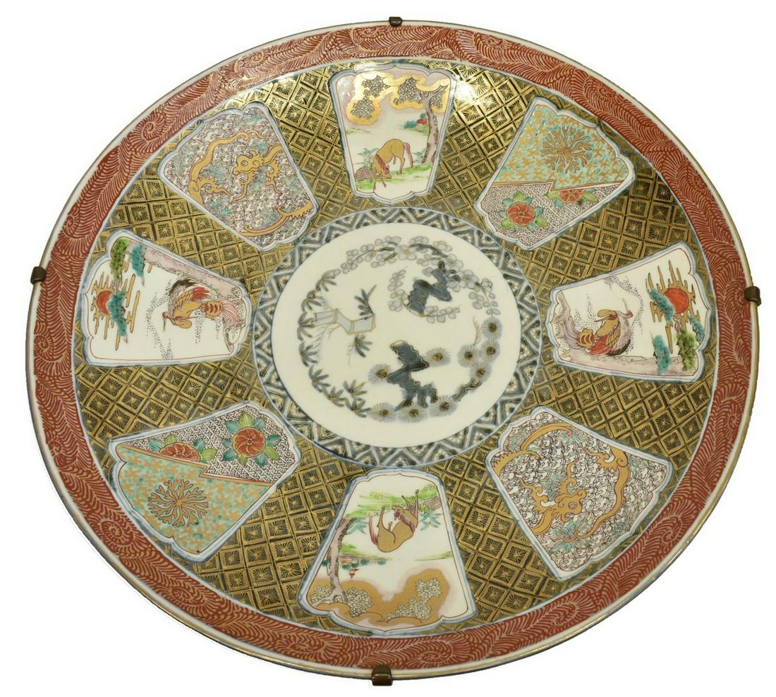 LARGE JAPANESE PORCELAIN CHARGER, 21.75"DIAM: Large Japanese porcelain charger, having red border, grey group with gilt diamond pattern, reserves showing cranes, horses, and floral motifs, central medallion with cherry blossom branch, apocryphal 
