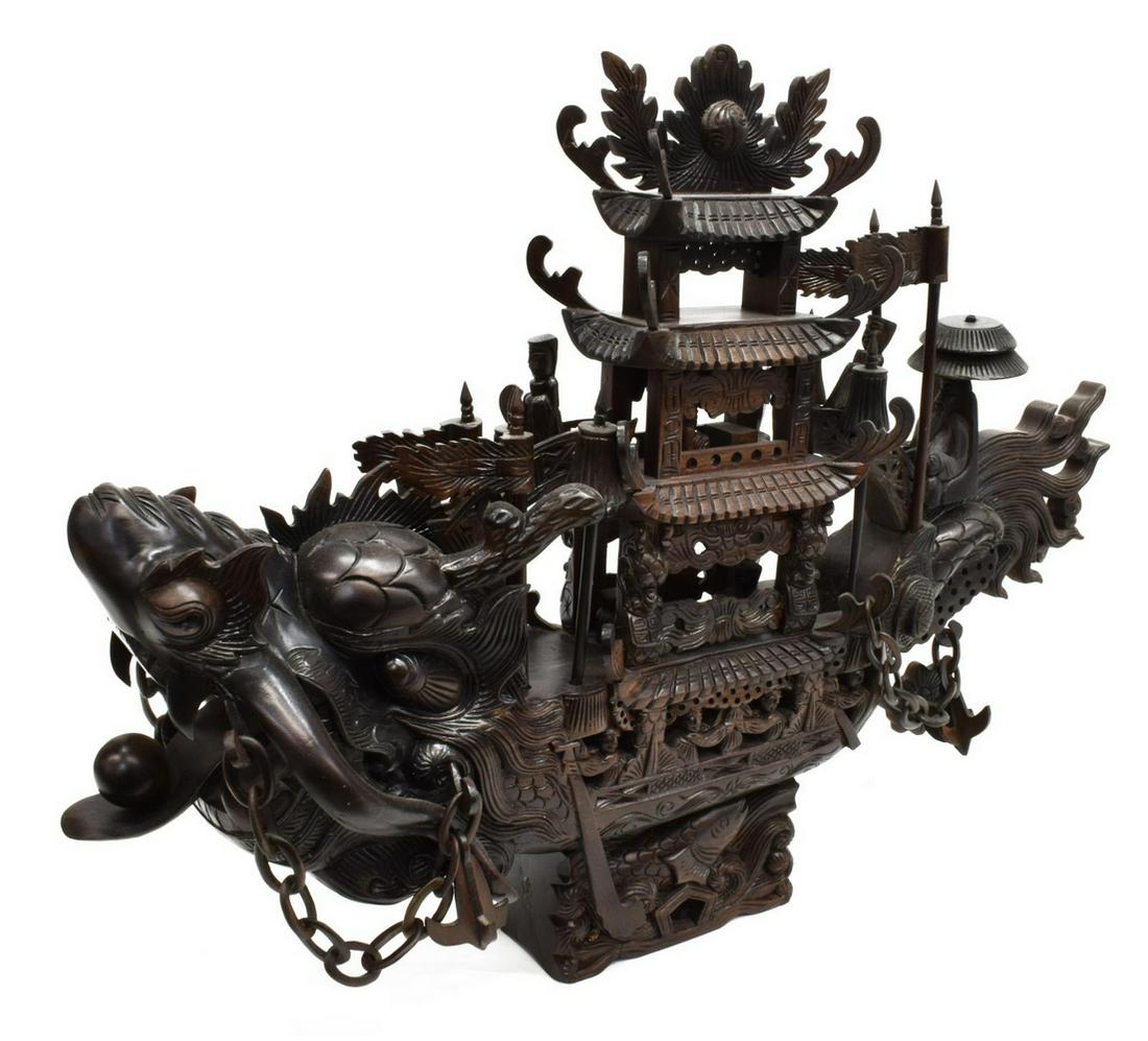 CHINESE INTRICATELY CARVED HARDWOOD DRAGON SHIP: Chinese intricately carved hardwood junk/ ship, in the form of a dragon, center with three-tiered pagoda, courtly figures, link chains with anchors at sides, on base carved with carp fish in relief, a