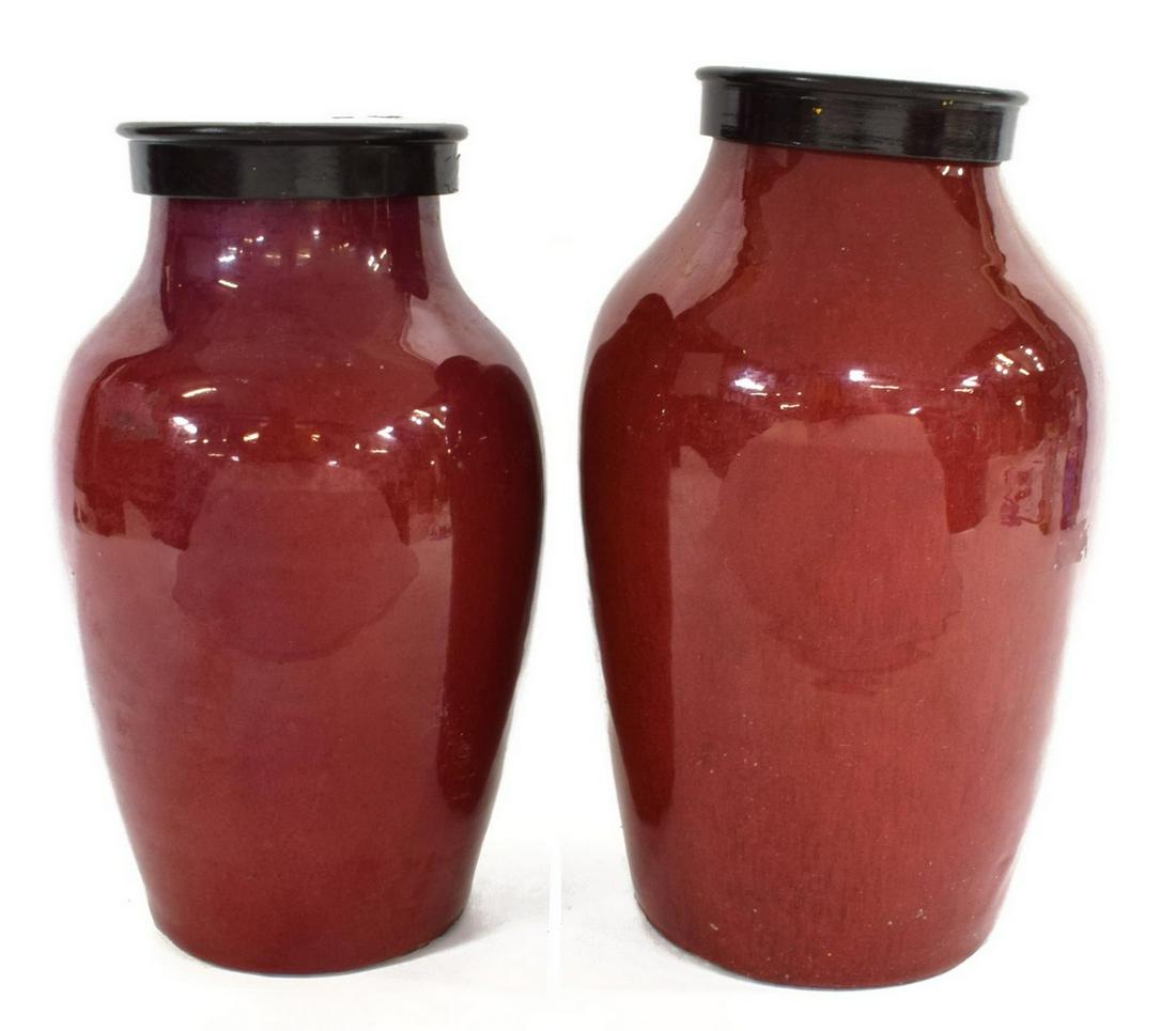 2) CHINESE CERAMIC OX BLOOD RED GLAZED LIDDED JARS: (pair) Chinese ceramic ox blood red glazed jars, with lid, reduced wide neck for conversion to lamp, tapered body, rising on circular foot, retaining wax seals, both with firing flaws to base, (one) w