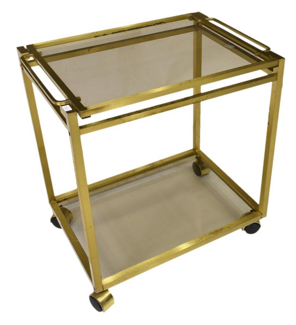 MODERN BRASS SMOKE GLASS TRAY TOP SERVICE CART: Modern service bar cart, c.1970s, having brass frame, removable tray top, with smoked glass lower tier, on wheels, approx 23.25"h, 22.75"w, 16.25"d Start Price: $100.00