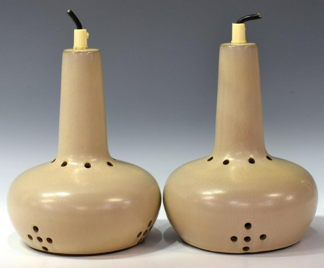(2) DANISH MID-CENTURY MODERN HANGING LIGHTS: (pair) Danish mid-century modern pottery single-light hanging lamps, mid 20th c., having single light hanging within round shade, with pierced dot design, in need of wiring, approx 8.25"h, 6.75"diam S