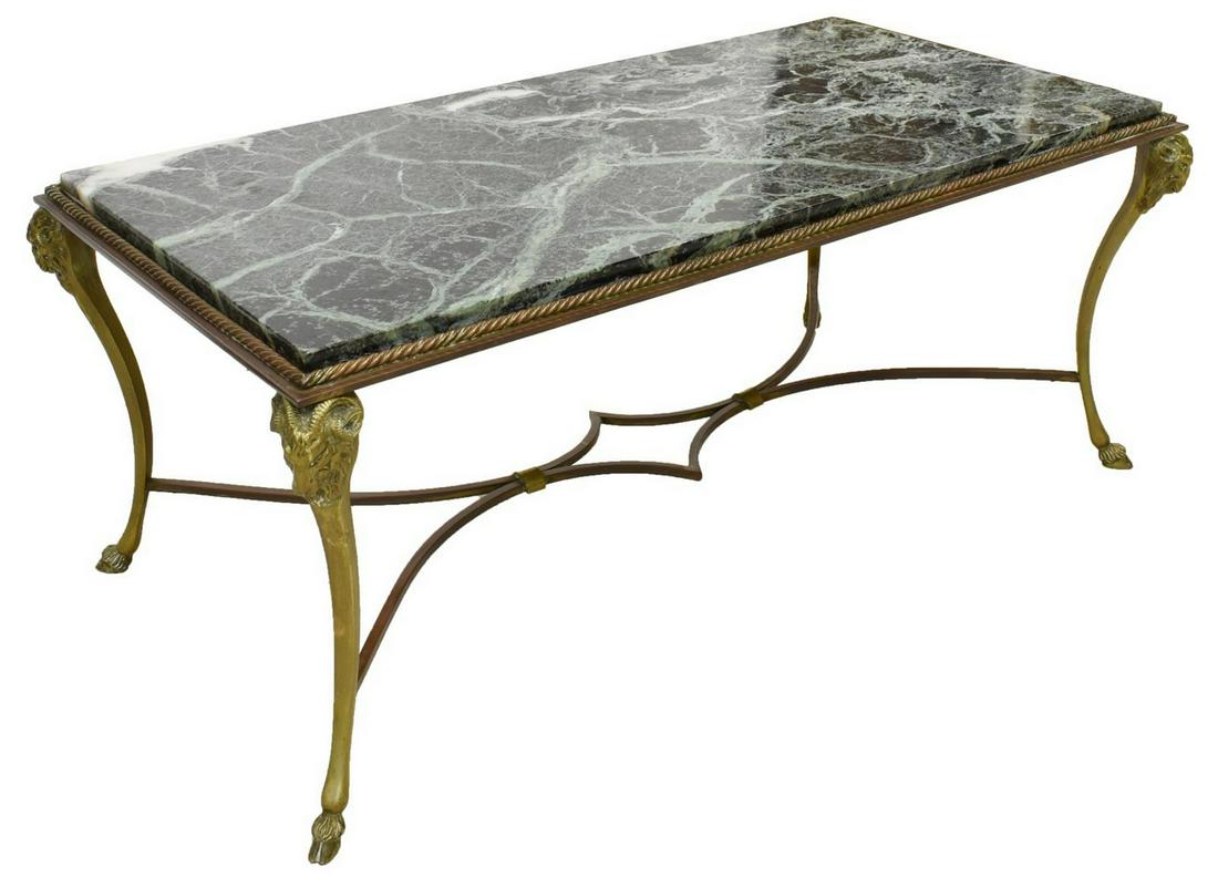 MANNER OF MAISON BAGUES MARBLE TOP COFFEE TABLE: French marble-top center table, 20th c., in the manner of Maison Bagues, the marble top over gilt metal frame, rising curved legs accented by ram's head at top, joined by shaped center stretcher, rest