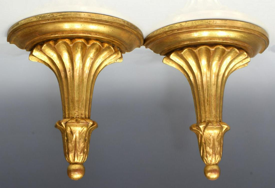 (PR) ARCHITECTURAL GILTWOOD WALL BRACKETS SHELVES: (pair) Architectural giltwood wall brackets, 20th c., the demilune top rising upon shaped standard, carved with foliate element above drop finial, approx 10"h, 9.5"w, 4.75"d; 2.75lbs total **Provenanc