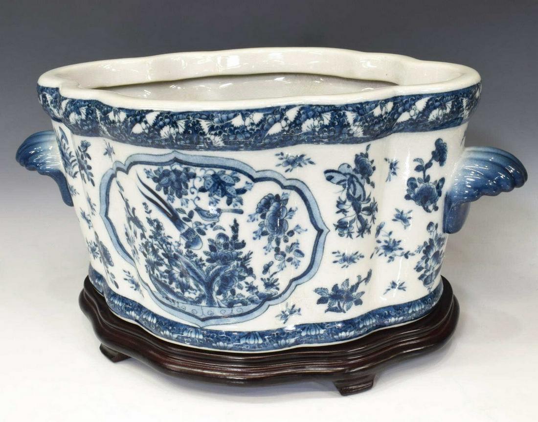 CHINESE BLUE & WHITE PORCELAIN PLANTER ON STAND: Chinese blue and white porcelain foot bath/ planter, Wong Lee, late 20th c., with shell-form handles, lobed body with reserves of birds on floral branches, marked underfoot, accompanied by wood stand,