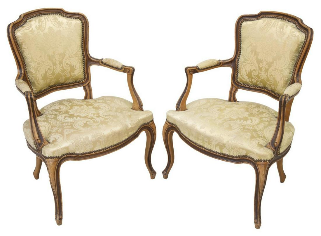 (2) FRENCH LOUIS XV STYLE UPHOLSTERED FAUTEUILS: (lot of 2) French Louis XV style armchairs, 20th c., having fruitwood finished frame, padded back, seat, and armrests in damask upholstery, accented with nail head trim, scrolled handholds, rising on 