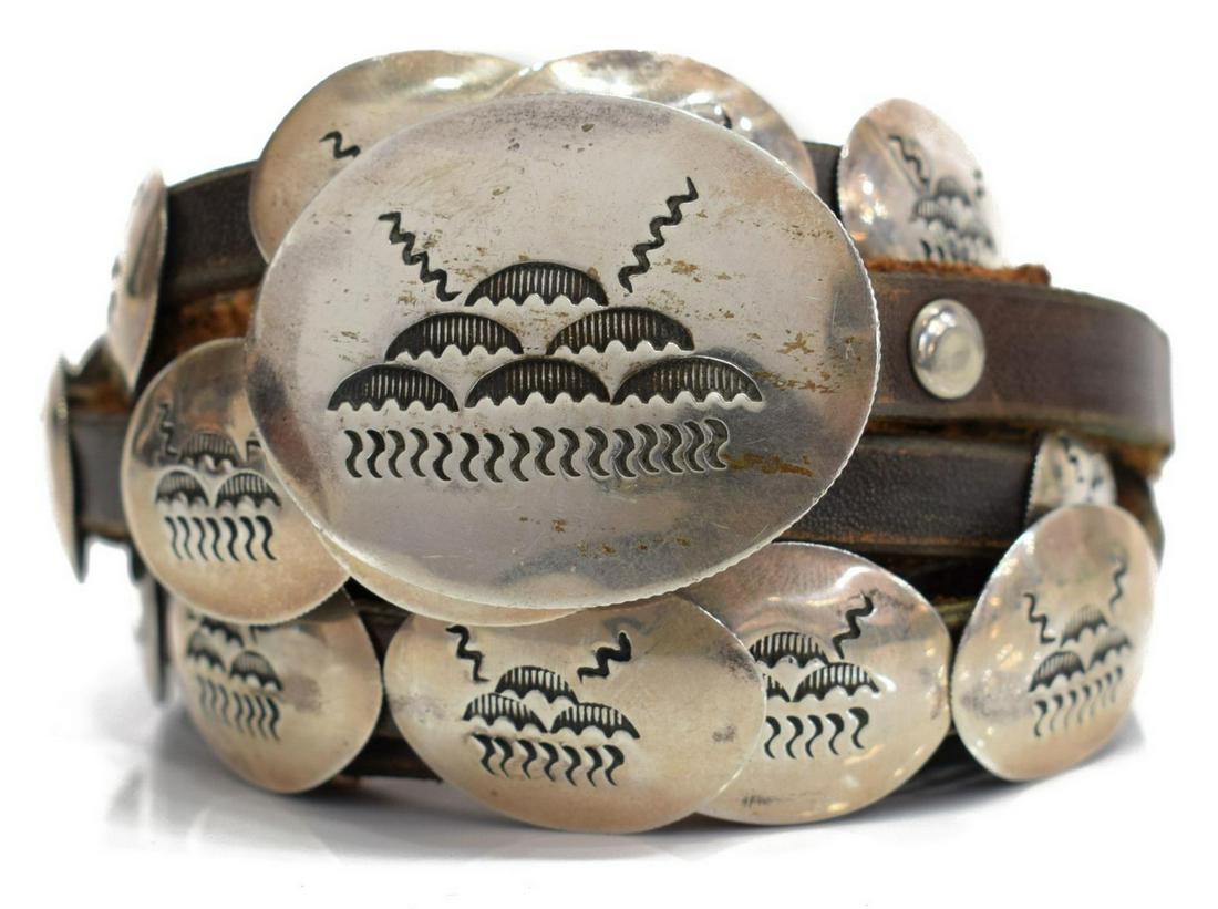 SOUTHWEST TAOS SILVER & LEATHER SIGNED CONCHO BELT: Estate Southwest silver (content unknown) concho belt, signed illegibly ?Tiger Rocha?, Taos Pueblo, dated 1998, (1) oval buckle and (3) matched conchos, on a leather belt with stitched extension / rep
