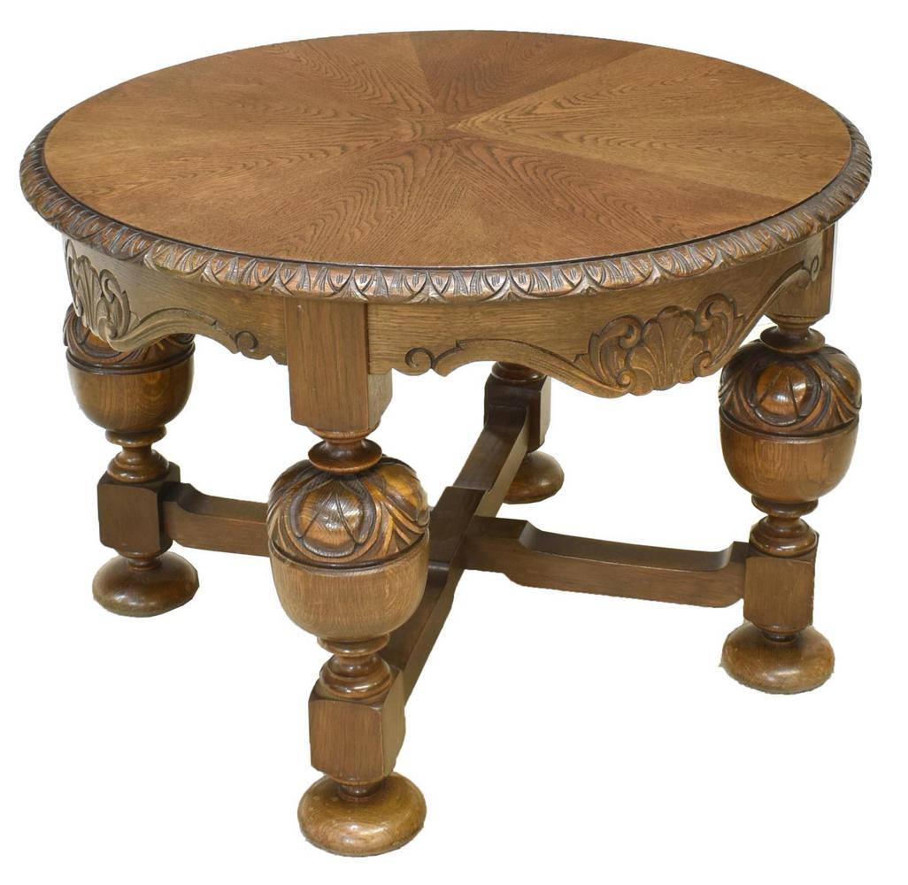 DUTCH BAROQUE STYLE OAK CIRCULAR COFFEE TABLE: Dutch Baroque style oak coffee table, 20th c., matched radiating circular top with molded edge, scalloped apron with shell carving, substantial turned supports, joined by cross stretcher, ending in bu
