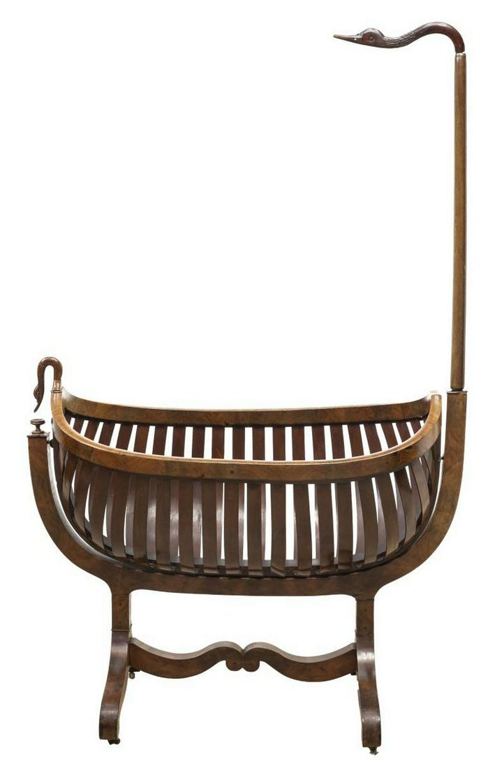 FRENCH EMPIRE STYLE SWAN'S NECK ROCKING CRADLE: French Empire style child's rocking cradle, mid 19th c., swan's neck supports, ribbed navette-form cradle, trestle base on wheels, approx 77.75"h, 49"w, 22"d **Note: for decorative use only** Start Pr