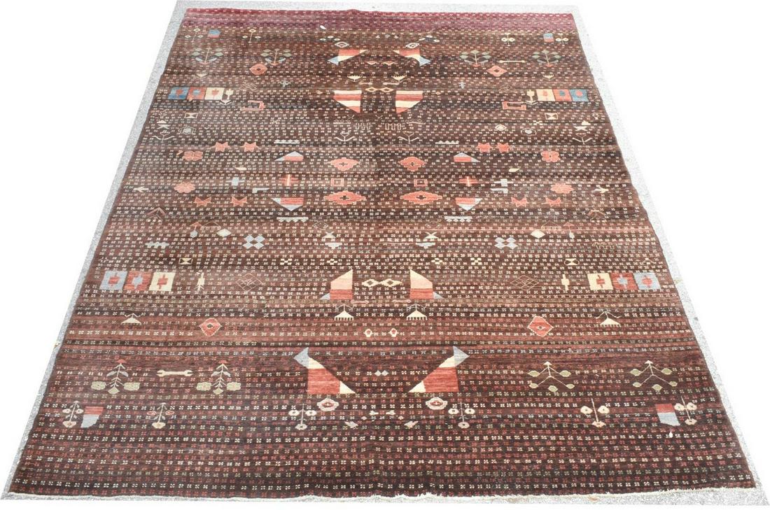 HAND-TIED POLYCHROME GEOMETRIC RUG, 11'9" X 8'10": Hand-tied rug, having polychrome striped ground, with geometric pattern, grey fringe to either end, approx 11'9"l, 8'10"w Start Price: $200.00