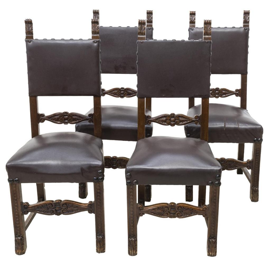 (4) ITALIAN RENAISSANCE REVIVAL DINING SIDE CHAIRS: (lot of 4) Italian Renaissance Revival walnut dining chairs, early 20th c., having foliate carved ears, brown faux leather upholstery, accented by oversized iron nail heads, rising on stretcher-joined