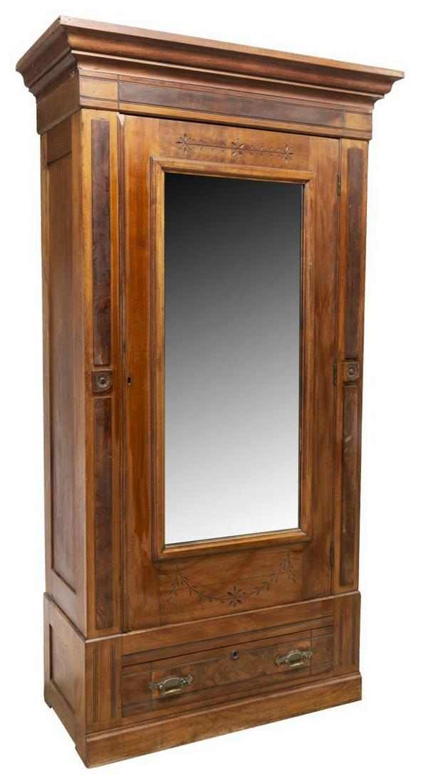 EASTLAKE MAHOGANY MIRRORED ARMOIRE: Eastlake mahogany armoire, late 19th c., having stepped cornice, above center cabinet door fitted with flat mirror plate, interior fitted with single clothes bar, above lower drawer, rising on block b