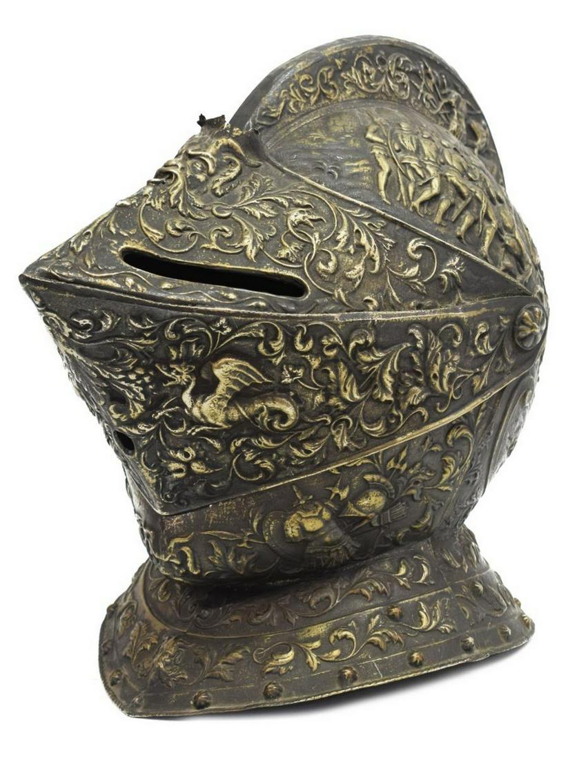 DECORATIVE SILVER-TONE METAL KNIGHT'S CLOSE HELM: Decorative silver-tone metal knight's close helm/ helmet, with scrolling foliates, masks, and figural scenes in relief, approx 13"h, 15"l, 9"w, 4.5lbs Start Price: $80.00