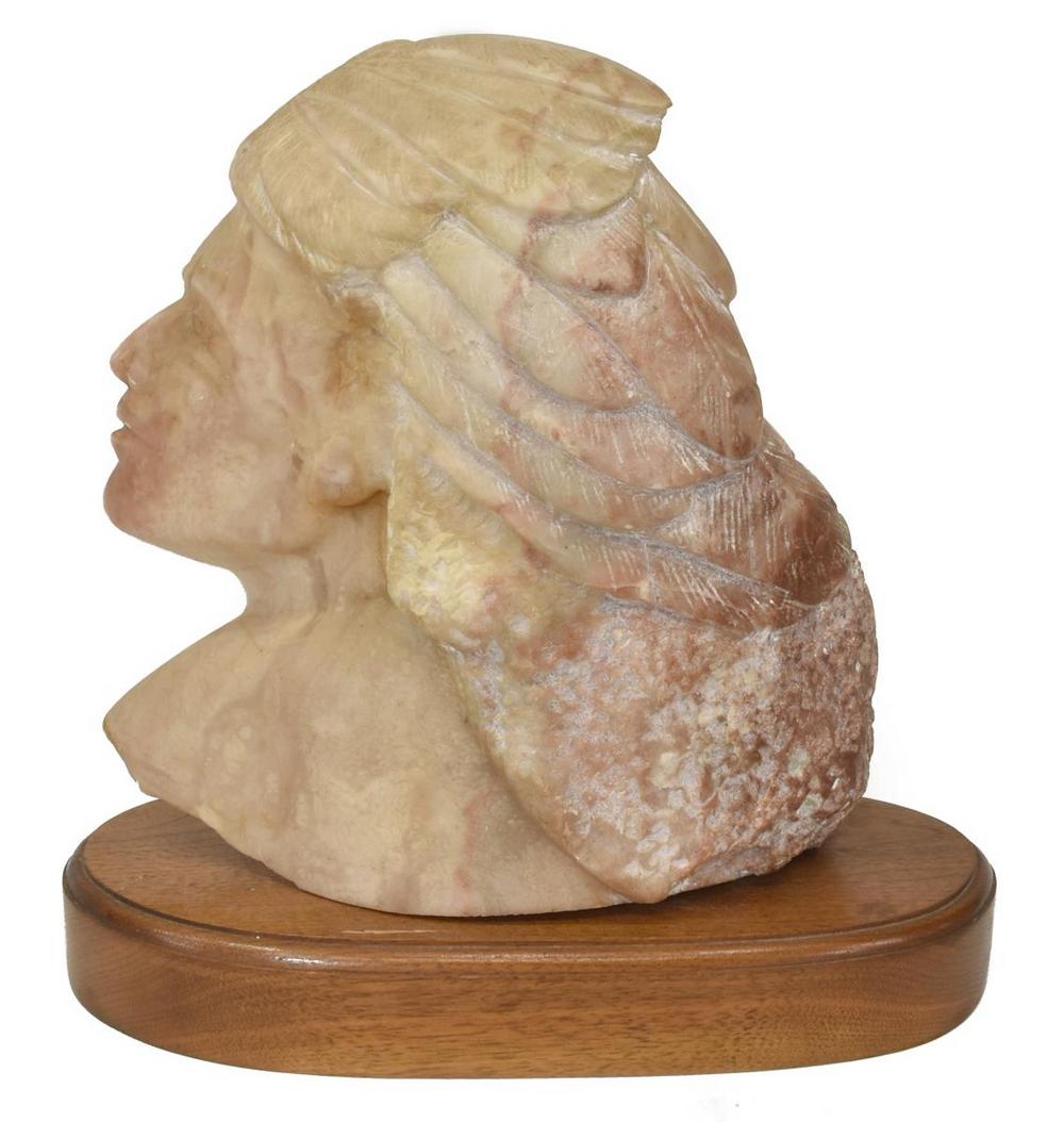 CINDY BURLESON (TX) CARVED NATIVE AMERICAN BUST: Well carved Native American alabaster bust, signed C. Burleson verso, (Cindy Burleson, Texas, 20thc.), chief depicted in side profile with well carved eyes, nose and mouth, adorned in feathered headdr