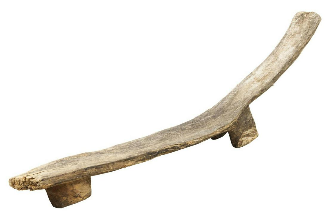 AFRICAN PRIMITVE RECLINING WOOD LOBI BENCH /STOOL: African primitive reclining Lobi bench / stool, Burkina Faso, carved from single wood block, in semi reclined form, rising on single leg at front, two legs at back, approx 20"h, 60.25"w, 7.5"d, 16lbs 