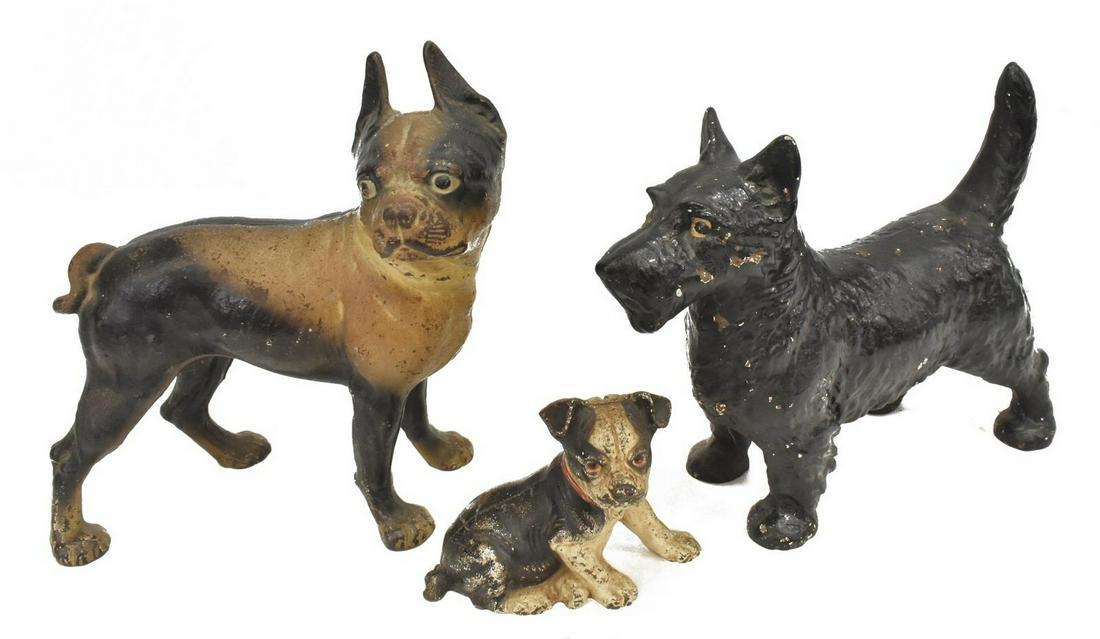 (3) CAST IRON DOG DOOR STOPS & COIN BANK, HUBLEY: (lot of 3) Cast iron dogs, including: (1) Boston terrier door stop, unmarked, attributed to Hubley Manufacturing Company, approx 10.5"h, 8"w, 4.75"d, (1) Scottish terrier door stop, approx 8.5"h, 12"w