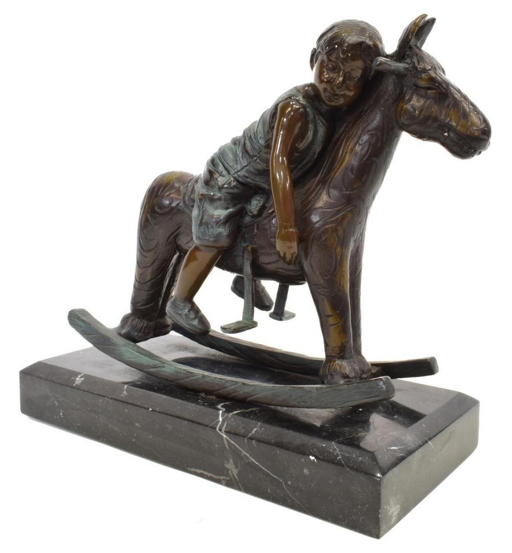 JIM DAVIDSON BRONZE SCULPTURE BOY ON ROCKING HORSE: Cast bronze sculpture, Little Boy On Rocking Horse, signed in cast Jim Davidson, stamp for Jim Davidson Foundry, on a black marble base, approx 10"h, 11.5"w, 5"d, 12lbs Start Price: $80.00
