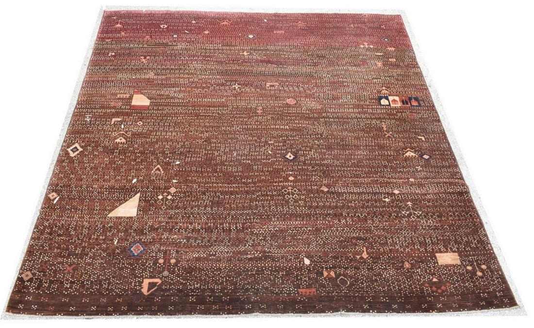 HAND-TIED POLYCHROME GEOMETRIC RUG, 10' X 9'8": Hand-tied rug, having polychrome striped ground, with geometric pattern, grey fringe to either end, minute tear to edge binding at one corner, approx 10'l, 9'8"w Start Price: $150.00