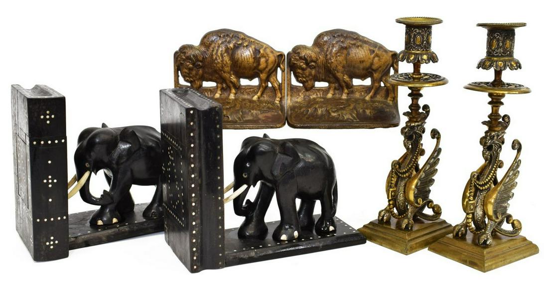 (2) GROUP METAL & WOOD BOOKENDS & CANDLESTICKS: (lot) Vintage bookend and candlestick group: (pair) Judd bookends, Bison, c. 1930, numbered 09695, cast iron in a bronze patina, marked to the back, approx 4"h, 5"l, 2"w; (pair) ebony elephant form bo