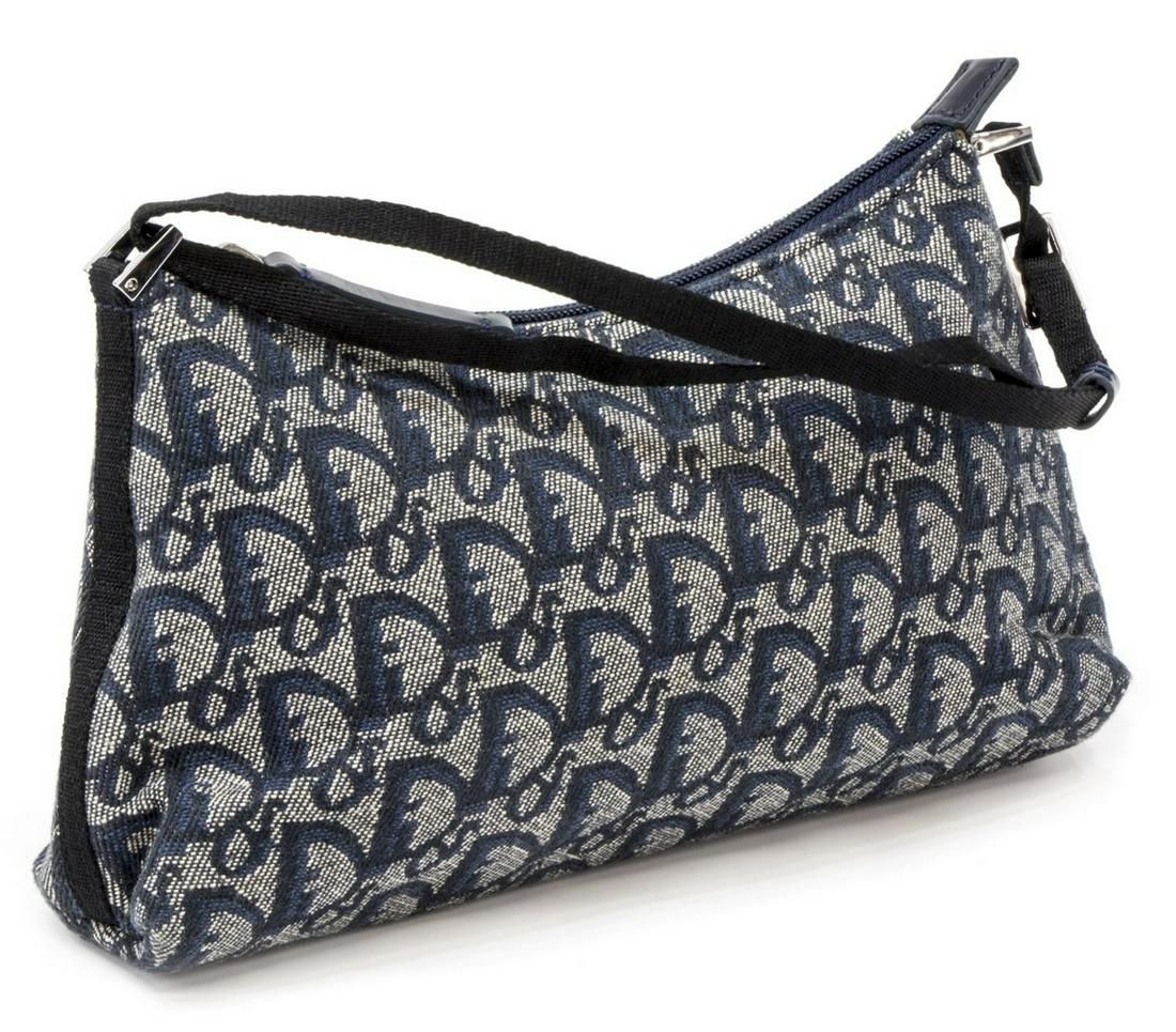 DIOR SMALL NAVY MONOGRAM CANVAS SHOULDER BAG: Christian Dior small navy monogram canvas shoulder bag, silver tone hardware, adjustable fabric strap over zippered opening with leather tab, lined navy interior with single interior slot pocket, reta
