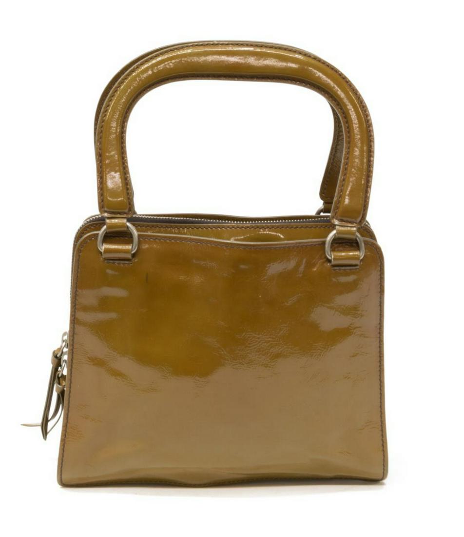 MIU MIU BROWN PATENT LEATHER HANDBAG: Miu Miu handled hand bag, in brown patent leather, with silver-tone hardware, dual flat handles, interior divided into two sections by center zip pocket, single interior zip pocket to one side, brown 