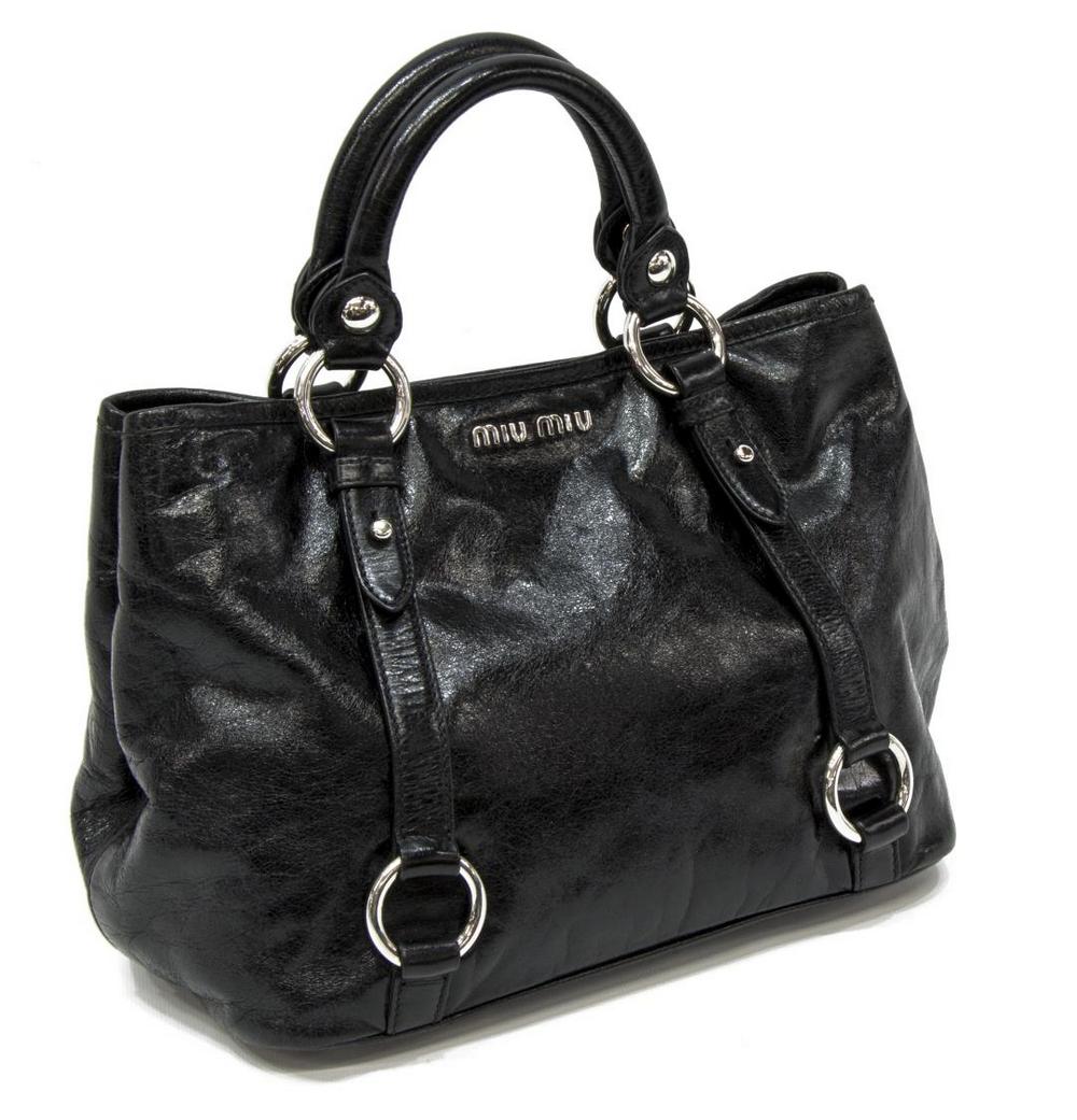 MIU MIU BLACK LEATHER HANDLE BAG: Miu Miu hand bag, in black leather, with silver-tone hardware, dual rolled top handles, logo adornment at front face, ring adornments at exterior trim, tonal satin lining, dual pockets at interior wal