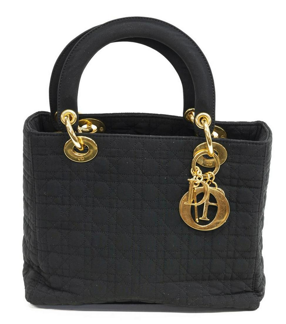 CHRISTIAN DIOR 'LADY DIOR' BLACK CANNAGE NYLON BAG: Christian Dior "Lady Dior" handbag, in black Cannage nylon, with gold-tone hardware, dual flat top handles, retaining logo charm embellishment, zipper closure at top opening to red signature jacquard 