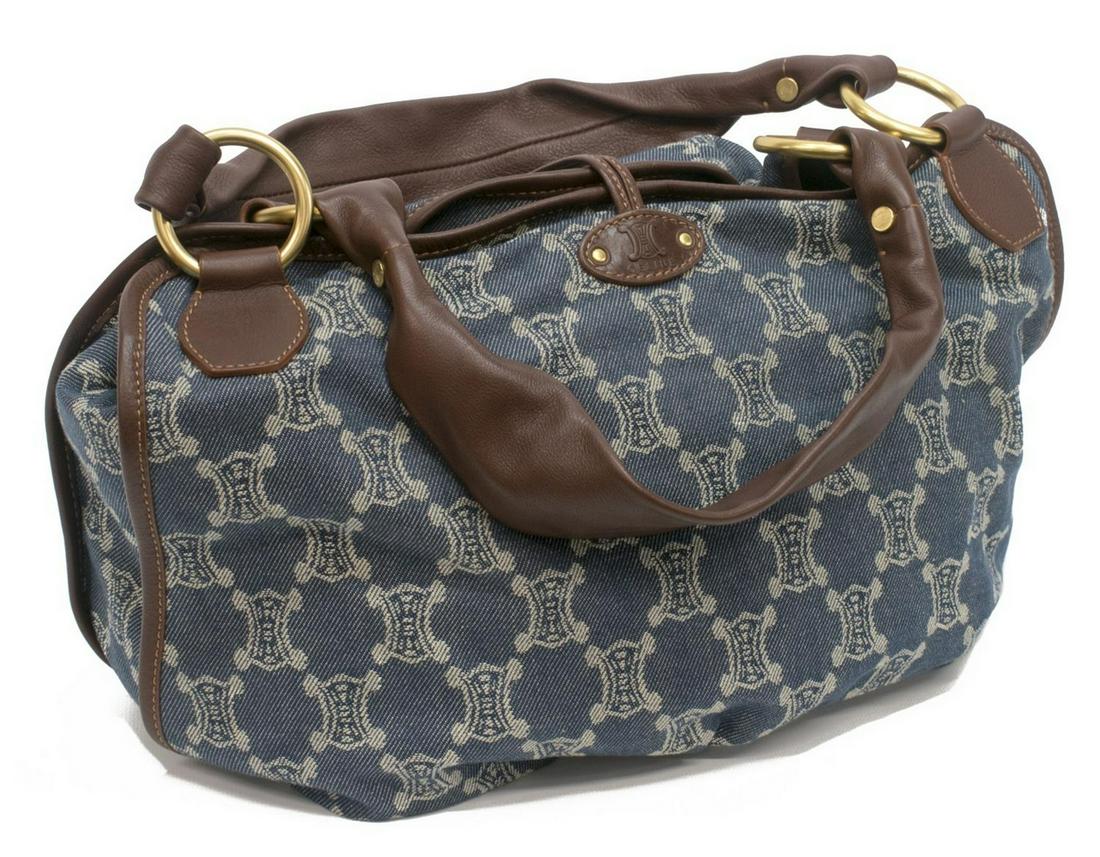 CELINE BLUE MACADAME DENIM CANVAS SHOULDER BAG: Celine "Bittersweet" blue Macadame denim canvas shoulder bag, snap and throw over cord closure with weighted end piece, having brown leather handles and trim, the interior with snap, zip and slotted p