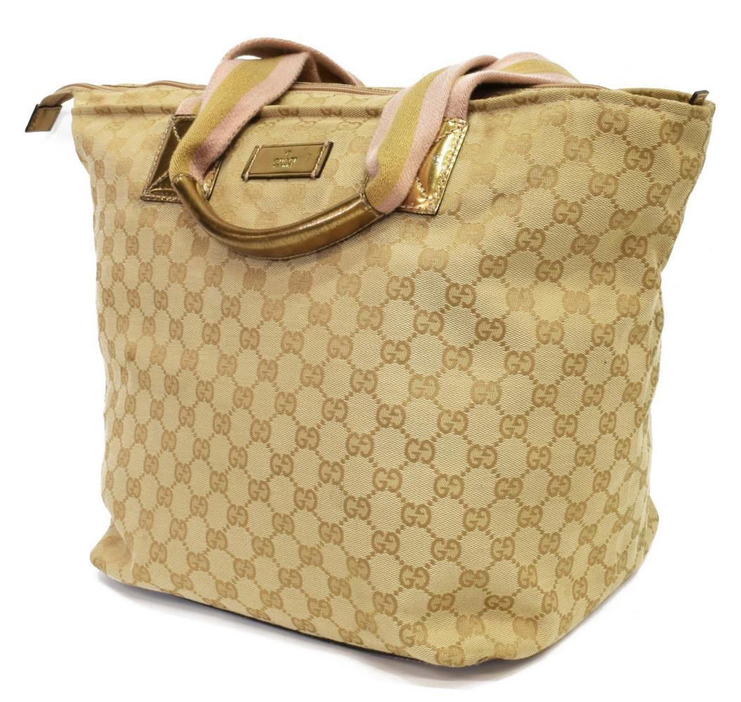 GUCCI TAN MONOGRAM CANVAS TOTE BAG: Gucci tote bag, in tan GG canvas, dual flat handles with gold-tone shoulder pads, zipper closure opening to dark brown woven lining, single small cell phone pocket to interior wall, some spotting, rub