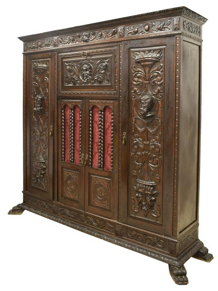 SPANISH RENAISSANCE REVIVAL CARVED BOOKCASE: Spanish Renaissance Revival heavily carved bookcase, 19th c., having cornice with running ornamentation, over case heavily carved with grotesques, floral and foliate motifs, fitted with upper drop-fro