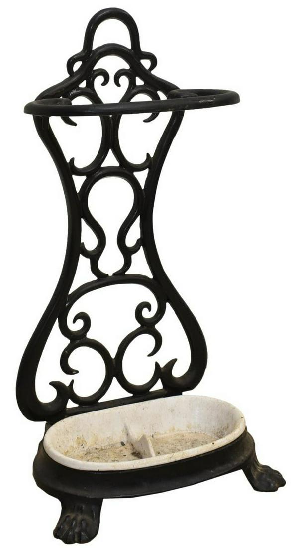 PAINTED CAST IRON UMBRELLA STAND: Cast iron umbrella stand, early 20th c., scrolled back over removable drip tray, rising on front paw feet, approx 25.25"h, 13.5"w, 8"d Start Price: $80.00