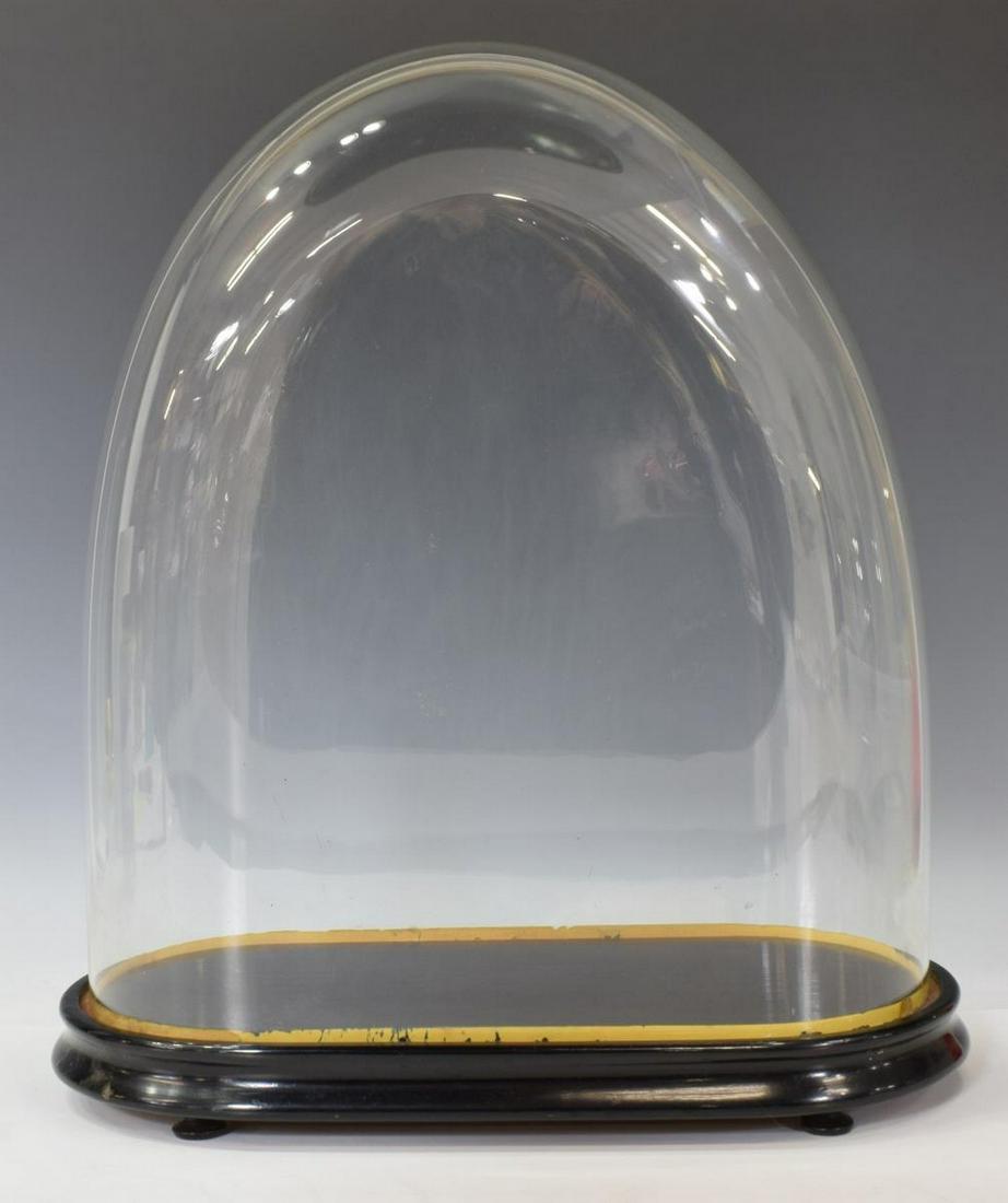 GLASS CLOCK CLOCHE DOME ON EBONIZED BASE: Glass cloche dome, 19th c., on an ebonized wood base, approx 18.25"h, 16 1/8"w, 7.75"d, 4.75lbs Start Price: $80.00