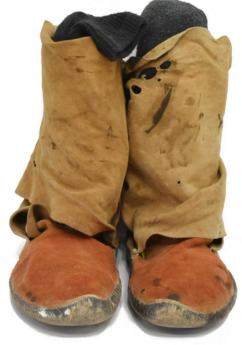 NATIVE AMERICAN NAVAJO HIDE MOCCASIN BOOTS: (pair) Navajo hide moccasins, first quarter 20th c., with red ocher pigment and leggings extensions, signed AJ Taylor, approx 9.5"h, 11"l, 4"w Start Price: $100.00