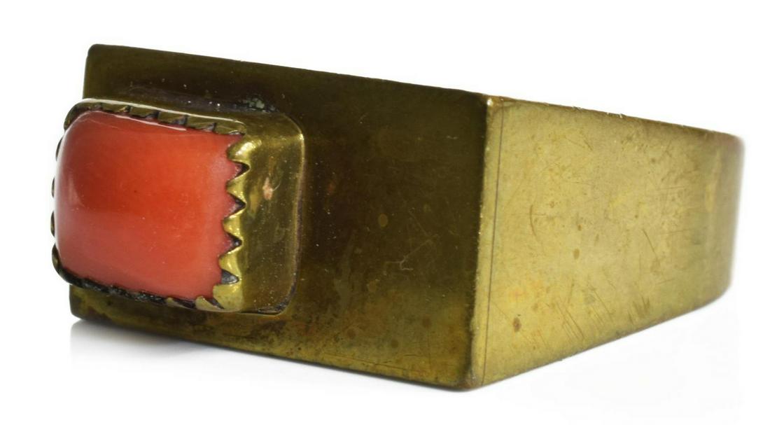 HARVEY CHAVARRIA SANTA CLARA BRASS & CORAL RING: Native American modernist ring, bearing hallmark for Harvey Chavarria (Santa Clara Pueblo, 1943-1991), executed in brass and set with red coral, stylized mark to interior as pictured, size 5.75, 10.6