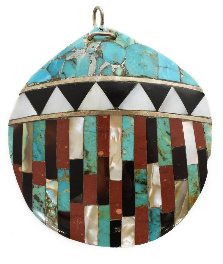 LARGE NATIVE AMERICAN INLAID SEASHELL PENDANT: Native American inlaid seashell pendant with silver, Santo Domingo Pueblo, turquoise, jet, red coral, abalone and mother-of-pearl in geometric patterns, plain shell back, approx 3"h, 2.75"w, 31 grams