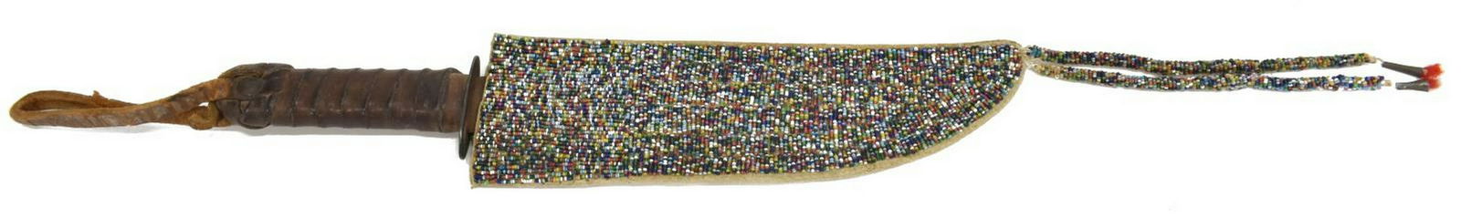 SIOUX 'CANDY CANE' BEADED SHEATH & TRADE KNIFE: Native American beaded knife sheath, Sioux, c.1920s, with 'candy cane' beading, two beaded tassels extending from one end, together with a trade knife, c.1900, approx 15.5"l, 3"w; 0.75lbs total Start
