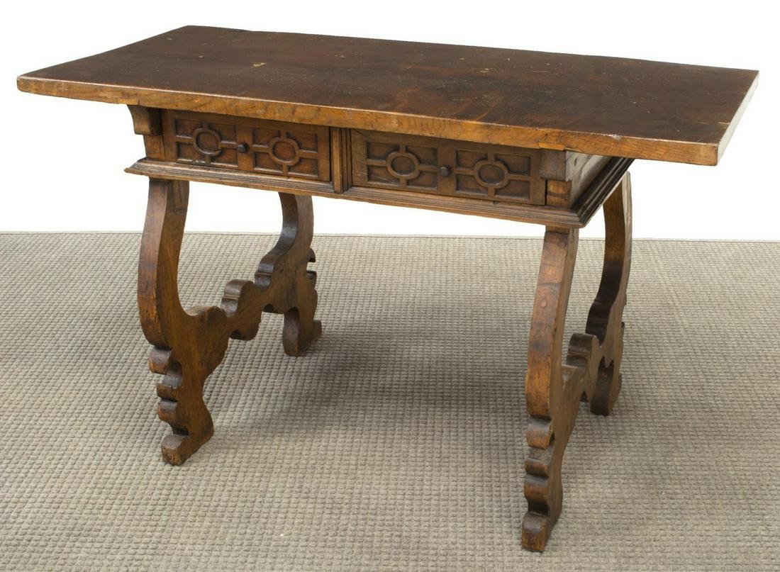 SPANISH WALNUT SINGLE-BOARD TOP WRITING DESK: Spanish walnut writing desk, 18th/ 19th c., having single board top, over two drawers, rising on ox yoke trestle supports, approx 30.5"h, 51.5"w, 23.75"d Start Price: $200.00