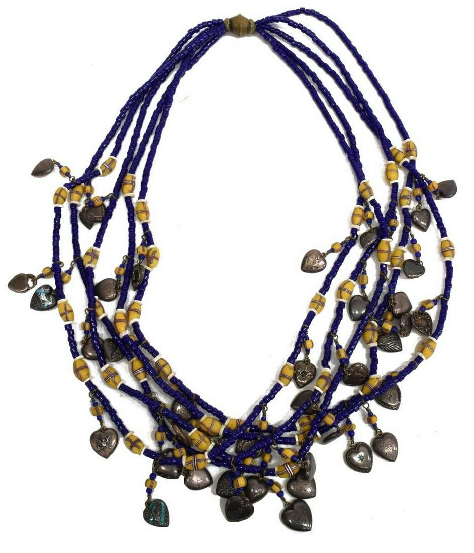 CANDACE DUNLAP 'DROP DEAD' BEADED NECKLACE: "Drop Dead" beaded necklace, Candace E. Dunlap, Santa Fe, New Mexico, assembled with vintage/antique cobalt blue glass beads, interspersed with a variety of yellow art glass beads, silver heart charms