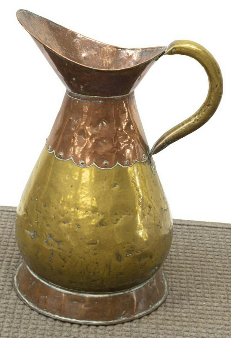 LARGE COPPER & BRASS HANDLED PITCHER, 23"H: Large copper and brass pitcher, late 19th c., applied handle, wide body, raised on circular foot, approx 23"h, 16.25"w, 14"d, 6lbs Start Price: $50.00