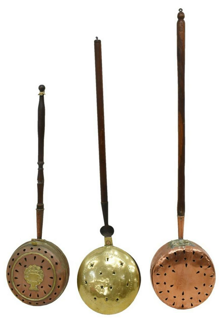 (3) FRENCH COPPER & BRASS BED WARMERS: (lot of 3) French copper and brass bed warmers, late 19th/ early 20th c., comprising: (1) copper lid depicting urn filled with flowers, pierced with diamonds and teardrops; (1) copper lid accented by 