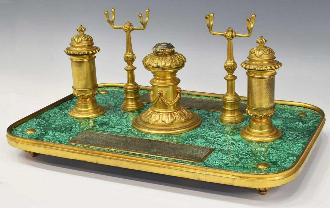 DORE BRONZE & MALACHITE DOUBLE INKWELL DESK STAND: Dore bronze and malachite encrier desk stand, possibly French or Russian, central candlestick flanked by double inkwells, raised pen rests, raised on toupie feet, approx 7.5"h, 15.75"w, 10.25"d Start