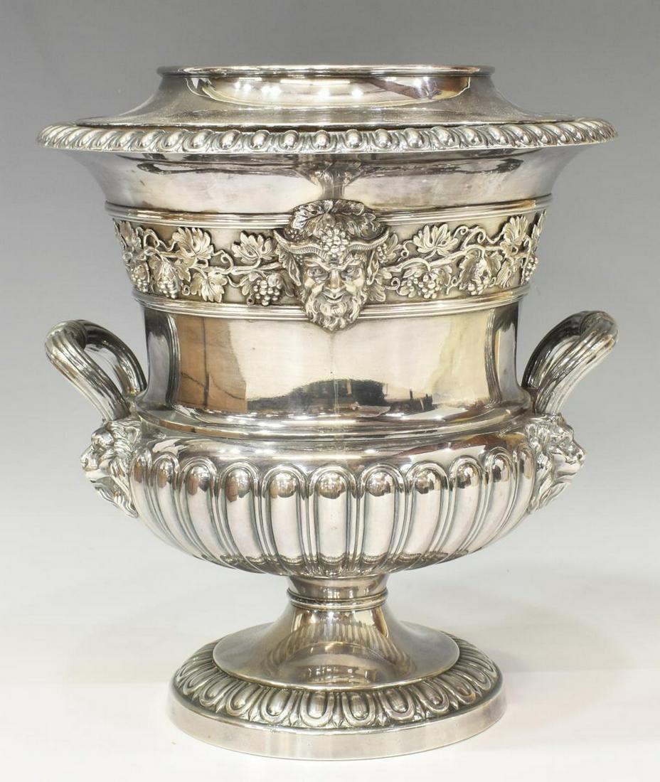 LARGE SILVER PLATE URN-FORM WINE BOTTLE COOLER: Large silver plate wine cooler, campana urn-form with gadrooned rim, grapevine band with satyr masks, reeded handles with lion's mask joins, raised on a pedestal foot, approx 11.5"h, 10"diam, 10lbs *P