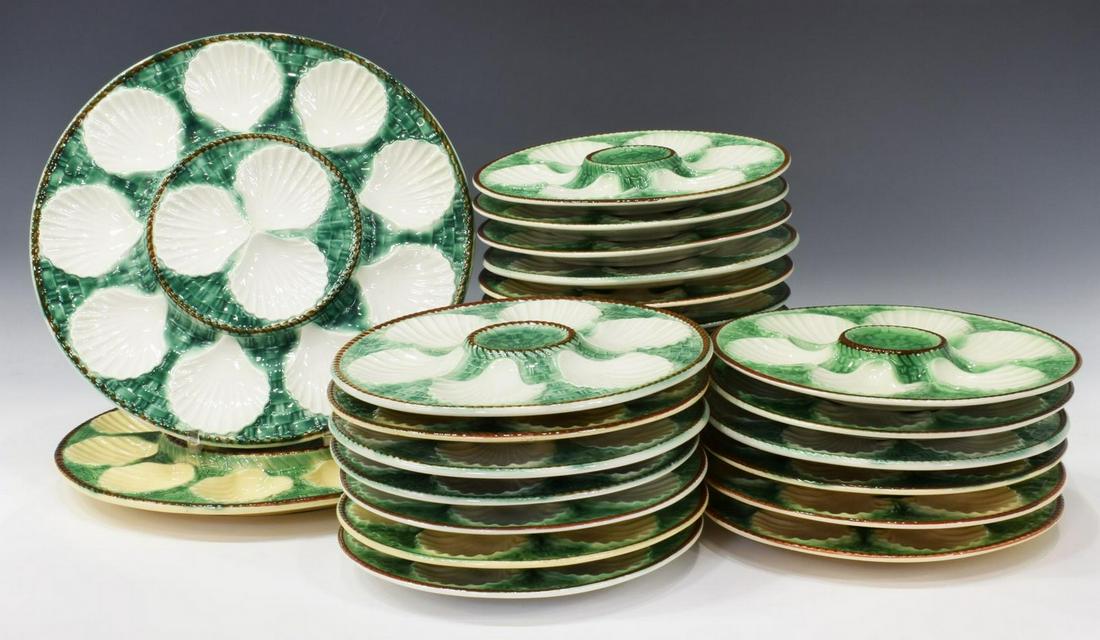 (26) FRENCH MAJOLICA OYSTER PLATES SERVICE: (lot of 26) French majolica oyster service, with white scallop shell shaped wells, against green glazed ground with embossed basket weave pattern, comprising: (2) large platters, approx 13"diam, (24) 